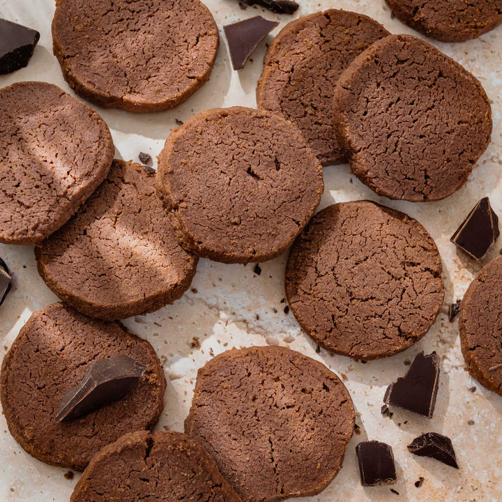Chocolate shortbread on a light surface with chocolate chunks.