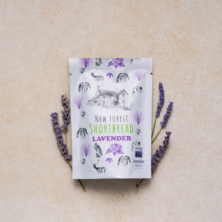 New Forest shortbread lavender snack pack with a display of lavender flowers on a neutral backdrop