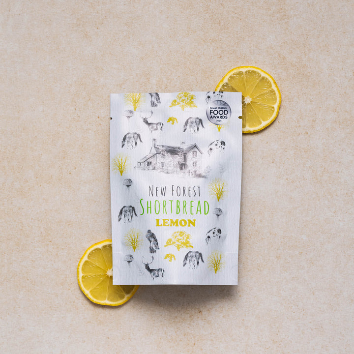 New Forest shortbread lemon snack pack with a display of  lemon slices on a neutral background
