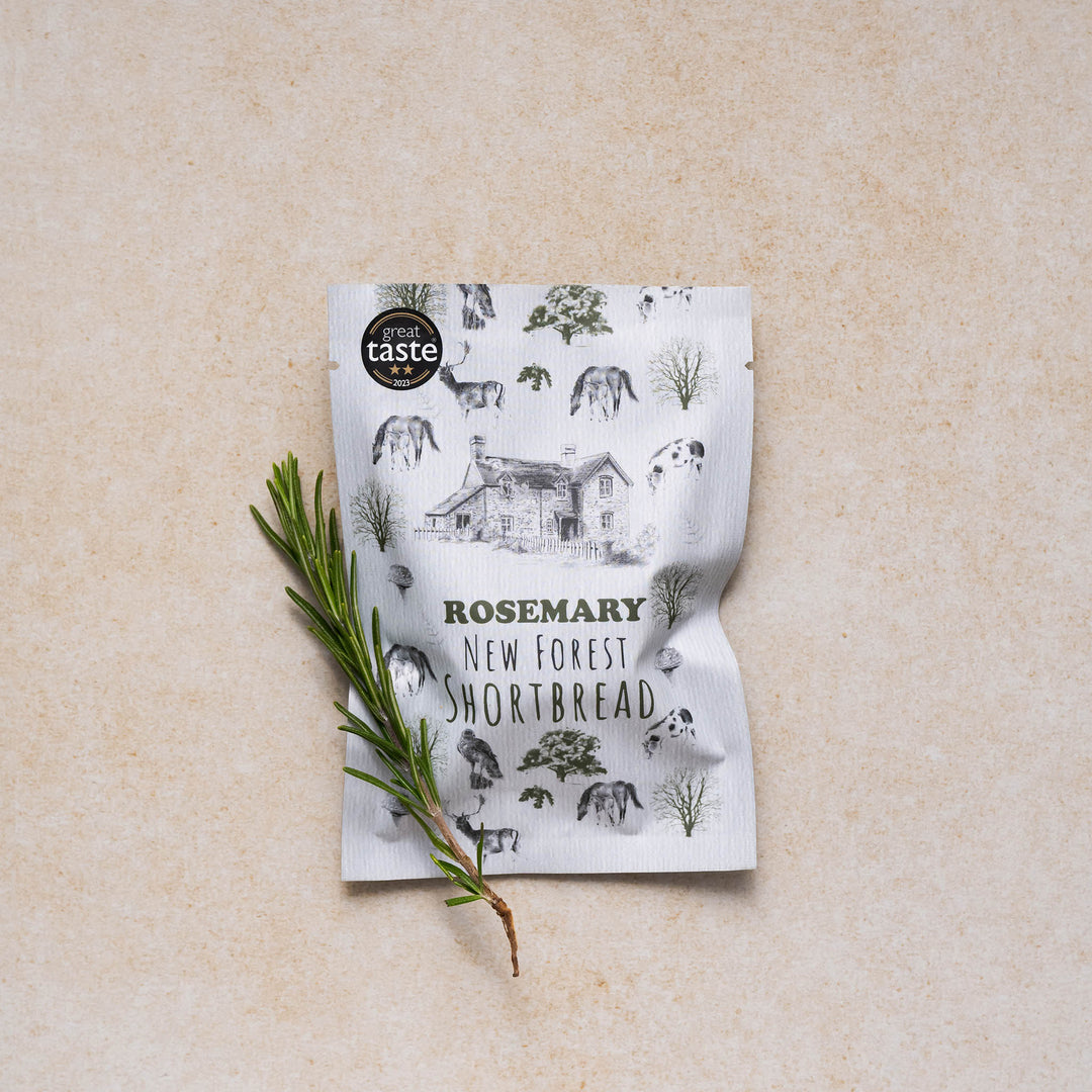 Rosemary New Forest shortbread snack pack displayed with a sprig of rosemary on a neutral backdrop